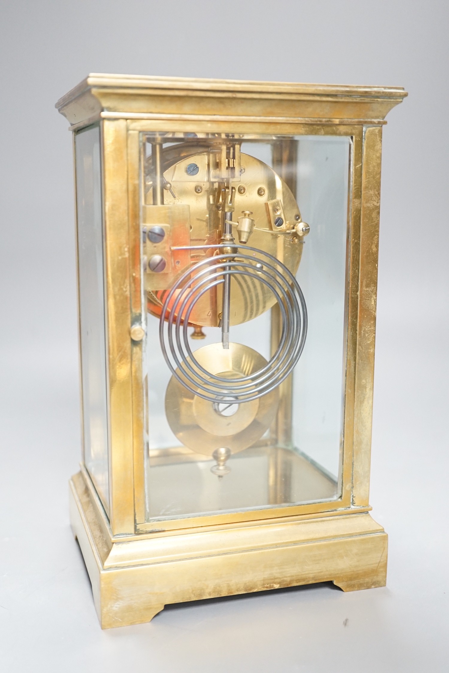 A French brass four glass mantel clock, 23cms high